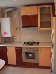 Kitchen with gas boiler and refrigerator photo