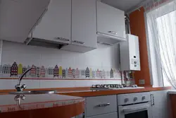 Kitchen with gas boiler and refrigerator photo