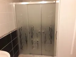 Photo on glass in the bathroom and toilet