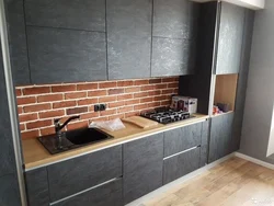 Photo of a kitchen without handles in loft style