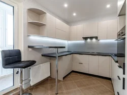 Kitchen with bar counter and TV photo