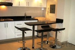 Kitchen with bar counter and TV photo