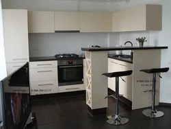 Kitchen with bar counter and TV photo