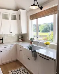 White kitchen with sink by the window photo