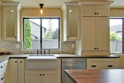 White kitchen with sink by the window photo