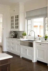 Белая кухня з мыйкай каля акна фота