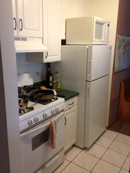 Gas pipe behind the refrigerator in the kitchen photo