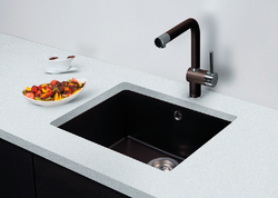 Black sink and faucet in the kitchen photo