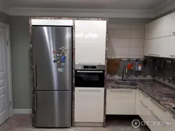 Kitchen refrigerator and oven next to each other photo