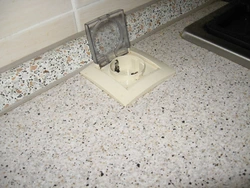 Sockets on the countertop in the kitchen photo in the interior