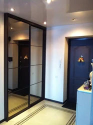 Wardrobe in the hallway with mirrors to the ceiling photo