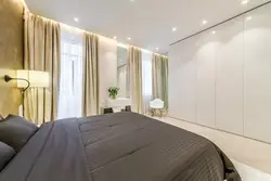 Wardrobe to the ceiling in the bedroom with suspended ceilings photo