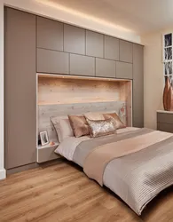 Photo of wardrobes in the bedroom on the entire wall with a bed