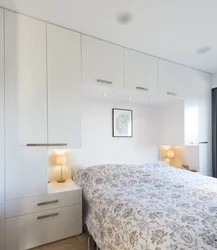 Photo of wardrobes in the bedroom on the entire wall with a bed