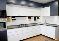 White Kitchen With Black Countertop And Bar Counter Photo