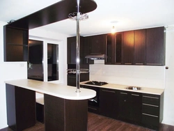 White kitchen with black countertop and bar counter photo