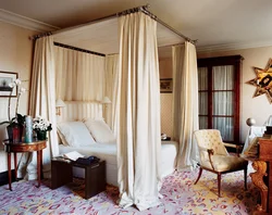 Bedroom interior with bed behind curtains