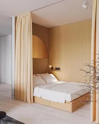 Bedroom interior with bed behind curtains