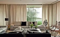 Floor-length curtains in the living room interior