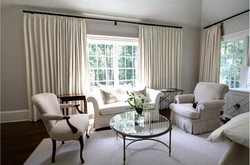 Floor-length curtains in the living room interior