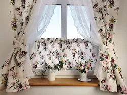 Curtains with roses in the kitchen interior