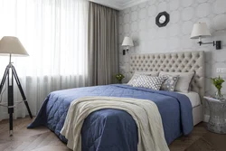 Curtains In The Interior Of A Bedroom With A Blue Bed