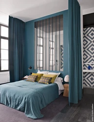 Curtains In The Interior Of A Bedroom With A Blue Bed