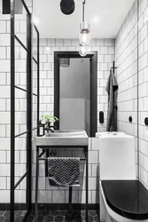 Black shower cabin in the interior of a white bath