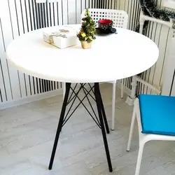 White Table With Black Legs In The Kitchen Interior