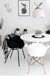 White table with black legs in the kitchen interior