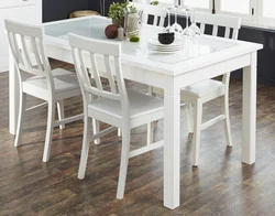 White Table With Black Legs In The Kitchen Interior