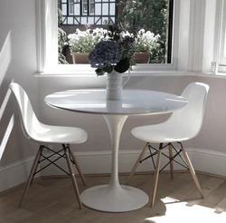 White Table With Black Legs In The Kitchen Interior