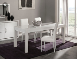White table with black legs in the kitchen interior