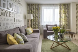 Curtains in a gray living room interior with a green sofa