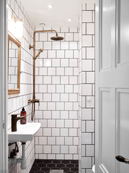 White tiles in the bathroom with black grout photo in the interior