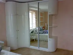 Corner wardrobe in the bedroom with mirrors and drawers photo