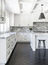 Kitchen With Black Countertop And Marbled Splashback Photo