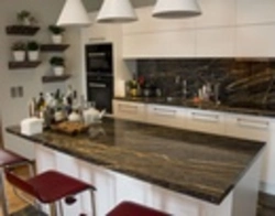 Kitchen with black countertop and marbled splashback photo