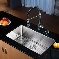 Kitchen sinks built into a stainless steel countertop photo