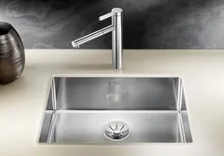 Kitchen sinks built into a stainless steel countertop photo