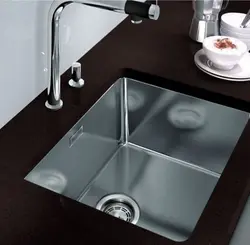 Kitchen sinks built into a stainless steel countertop photo