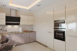 Kitchen design with built-in appliances and refrigerator photo