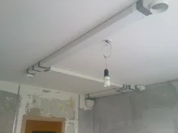 Hood under a suspended ceiling in the kitchen photo