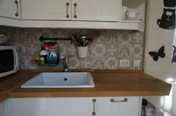 Sink on a wooden countertop in the kitchen photo