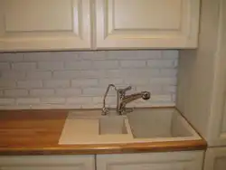Sink on a wooden countertop in the kitchen photo