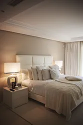 Cream bed in the bedroom interior