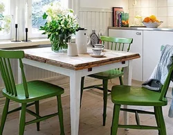 Photo of a kitchen with green chairs