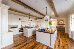 Photo of a white kitchen in a wooden house