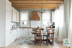 Photo of a white kitchen in a wooden house