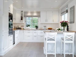 Photo of a white kitchen in a wooden house